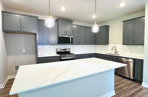 With accent gold pendants and pulls, this kitchen is a true showstopper. Picture is of actual home!