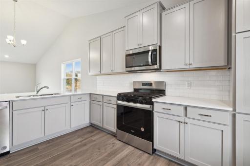 Photo for 12256 77th Street NE, Otsego, MN 55330 - listing #7140871 Breakfast bar and eat in kitchen featuring open layout. This home could be great for entertaining. *Picture of model home; actual finishes may vary.