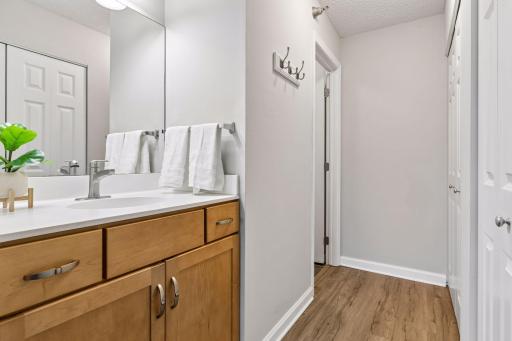 Private primary ensuite offers a 3/4 bath and two large closets and a separate vanity with storage