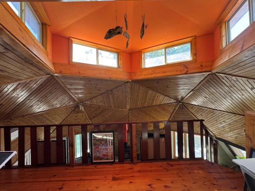 Upper level loft with lots of angles, high ceiling, gorgeous woodwork & plenty of sunshine.