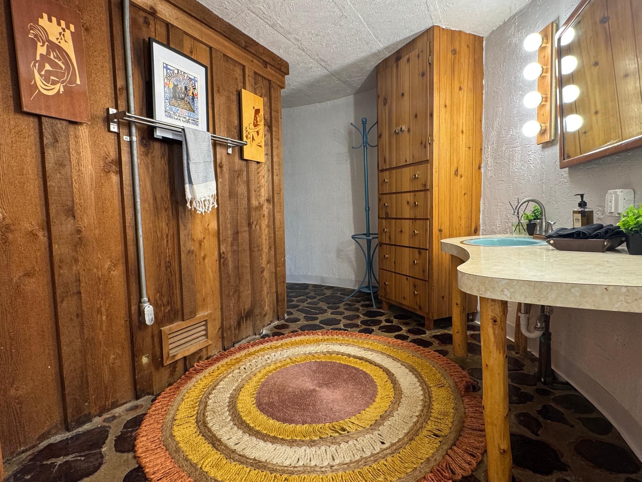 Sauna roomwith shower and vanity.