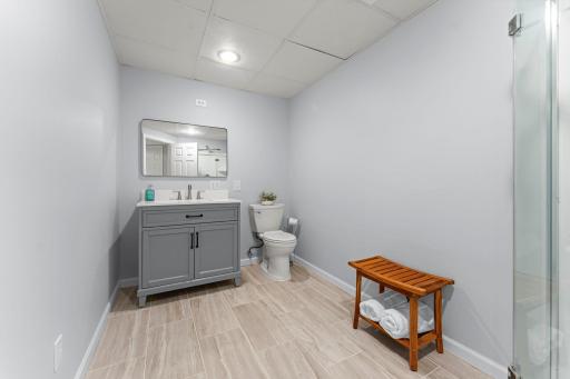 The updated lower level ¾ bathroom features a single vanity and walk-in shower.