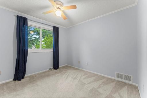 Bedrooms two and three are generously sized and each offer ceiling fans and ample closet space, with convenient access to the shared walkthrough bathroom.