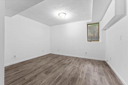 A fourth bedroom offers luxury plank flooring and an egress window.