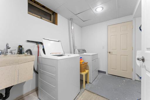 The laundry room is conveniently located nearby and provides access to a spacious storage room.
