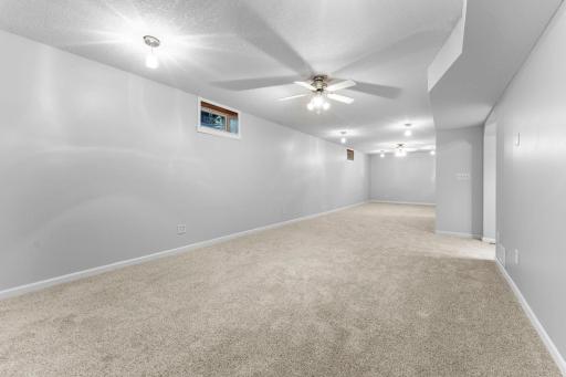 The finished lower level provides even more living and entertaining space with an expansive family room, ceiling fans, and new carpeting.