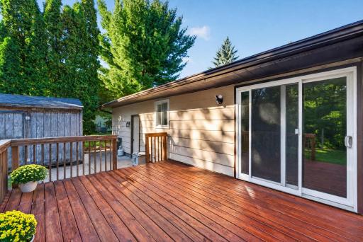 The spacious deck, patio area, fire pit, and storage shed provide plenty of space for gatherings, relaxing, and outdoor activities, while the shed offers additional storage.