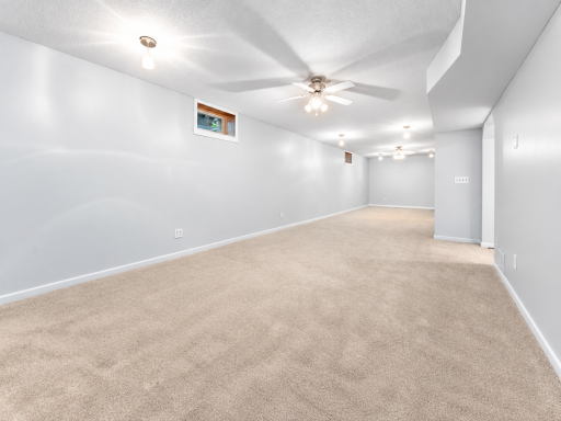 The finished lower level provides even more living and entertaining space with an expansive family room, ceiling fans, and new carpeting.