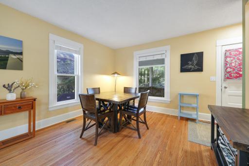 The open dining area is surrounded by natural light and offers plenty of space to gather around the table.