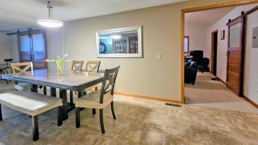 Open-concept layout seamlessly connects the dining area, living room, and kitchen, creating a spacious and inviting setting for everyday living and entertaining.