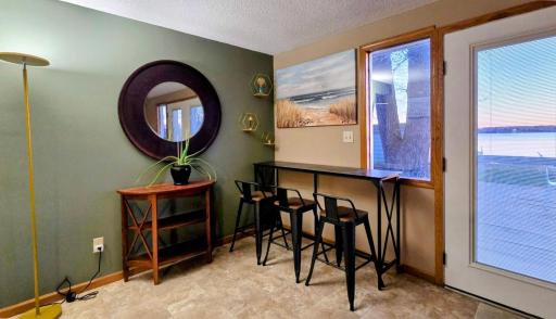 Open-concept layout seamlessly connects the dining area, living room, and kitchen, creating a spacious and inviting setting for everyday living and entertaining.