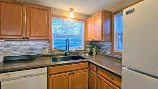 Spacious kitchen with a large island table, perfect for entertaining and meals, complemented by beautiful lake views.
