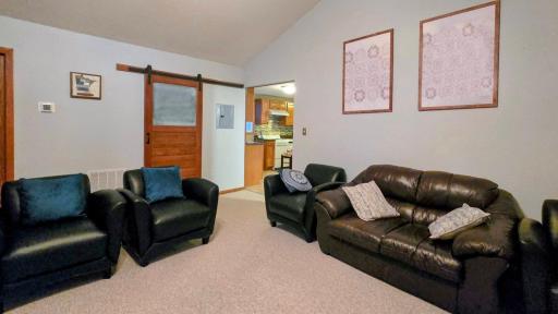 Open-concept layout seamlessly connects the dining area, living room, and kitchen, creating a spacious and inviting setting for everyday living and entertaining.