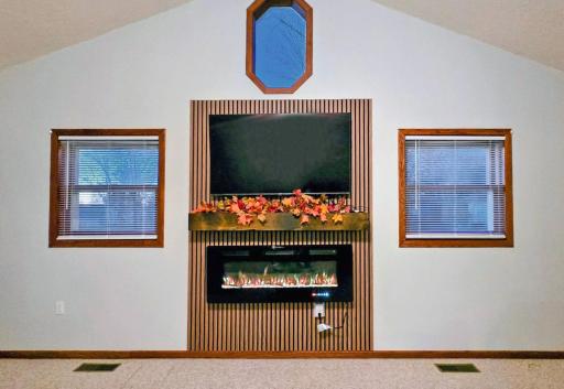 Cozy living room featuring a fireplace, creating a warm and inviting space for relaxing and entertaining.