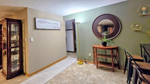 Open-concept layout seamlessly connects the dining area, living room, and kitchen, creating a spacious and inviting setting for everyday living and entertaining.