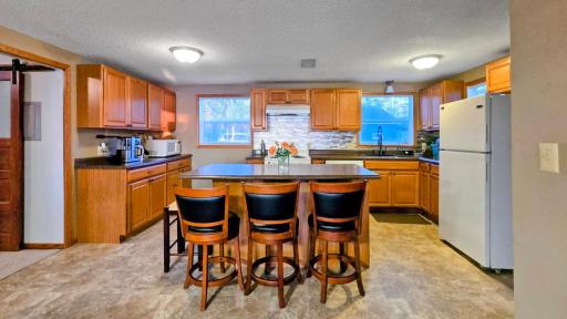 Spacious kitchen with a large island table, perfect for entertaining and meals, complemented by beautiful lake views.