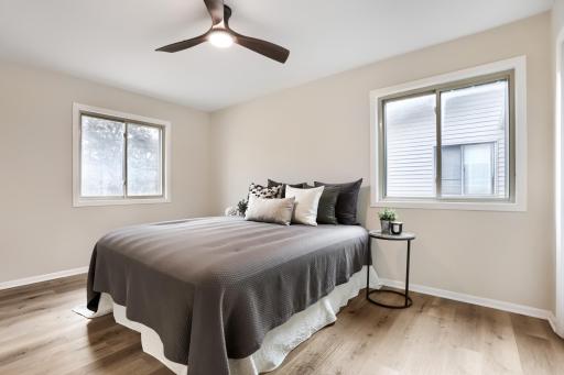 Primary bedroom with natural light, closet space, and ceiling fan.