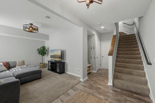 As you enter the home, you’re welcomed by a foyer with luxury plank flooring and access to the attached two-car garage.
