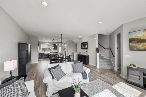 Upstairs, the main level offers an open-concept layout with luxury plank flooring throughout.