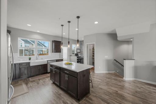 Another view of the kitchen, featuring the walk-in pantry, office nook, and access to the deck.