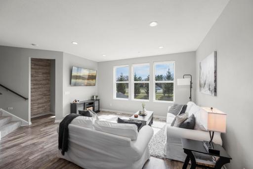 Another view of the main-level living room, showing access to the nearby main-level half bathroom.