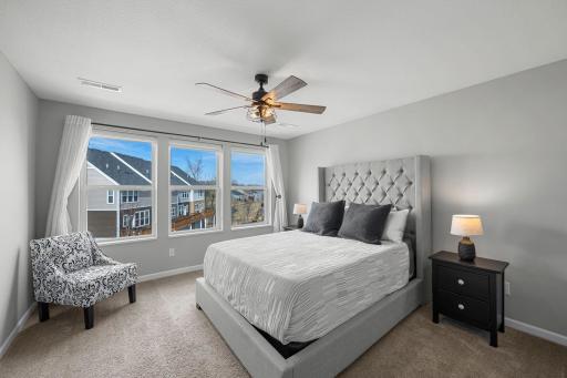 Upstairs, you’ll find three bedrooms, including a spacious primary suite with carpeting, a ceiling fan, large windows, and an 8x6 walk-in closet with built-ins.