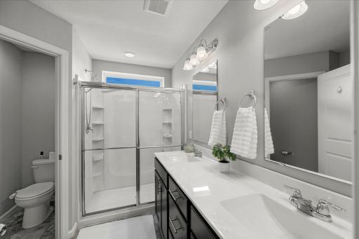 The private ensuite ¾ bathroom includes dual vanities, a walk-in shower, and a separate water closet.