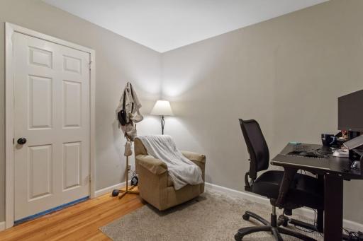 Flexible bonus room off the primary bedroom with fresh neutral paint, gleaming hardwood floors, and crisp white six-panel doors and trim. Currently an office, but perfect as a nursery, playroom, or cozy retreat.