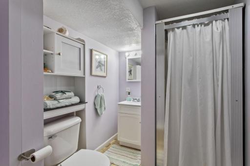 Crisp, clean lower-level Â¾ bath with fresh paint & a charming, updated feel. Convenient over-the-toilet organizer/medicine cabinet stays with the home for added storage. The utility room has a full sized washer & dryer and laundry tub, plus storage.