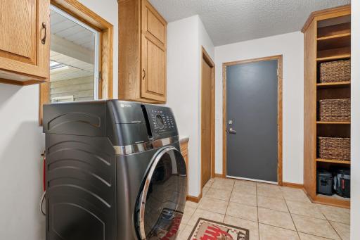 The mudroom has ample storage space. New GE washer/dryer all-in-one in 2025.