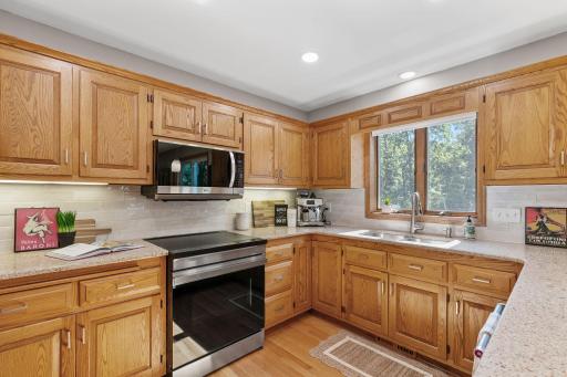 Kitchen window overlooks the serene backyard.