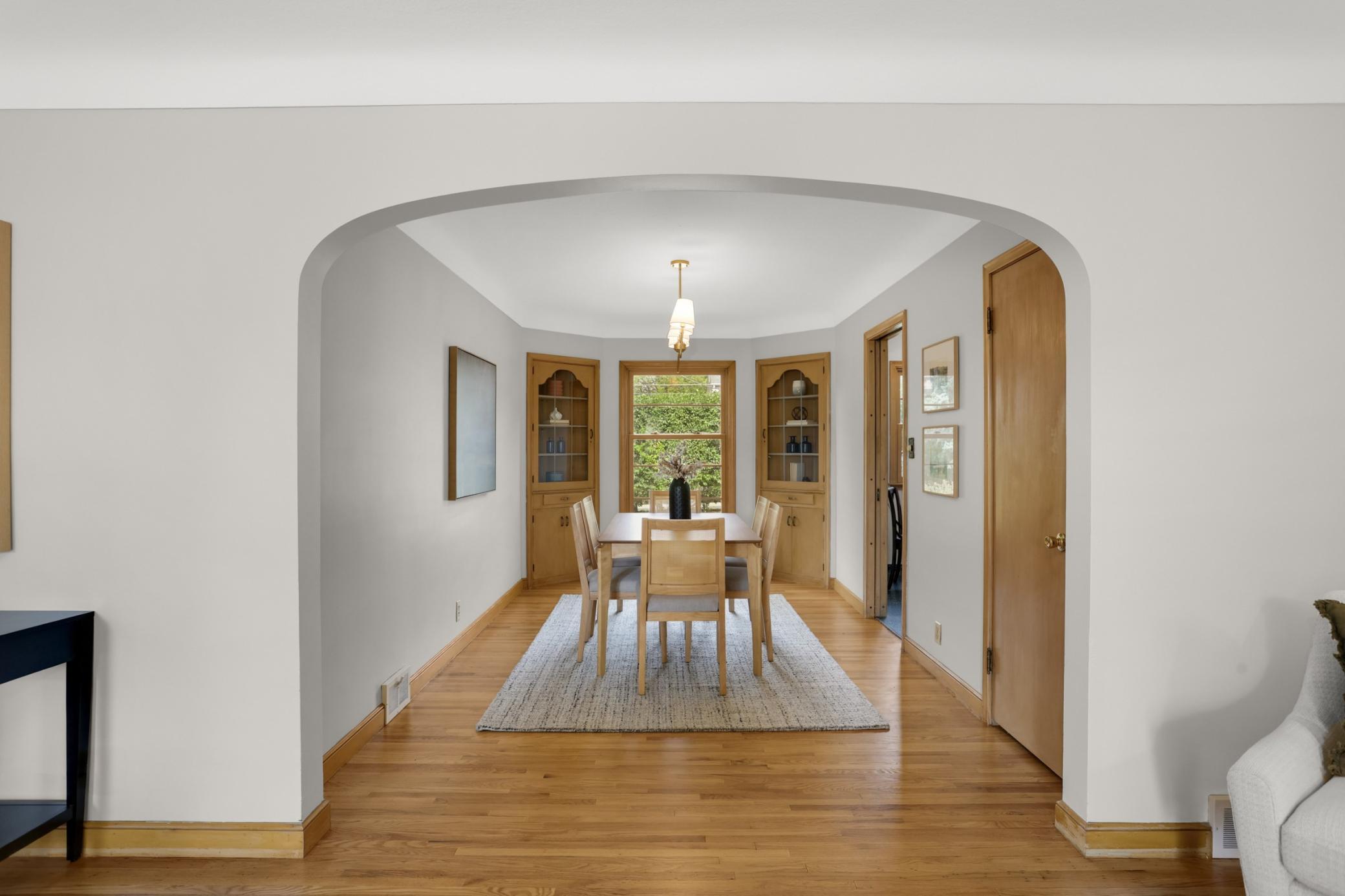 Formal dining room features built in corner cabinets