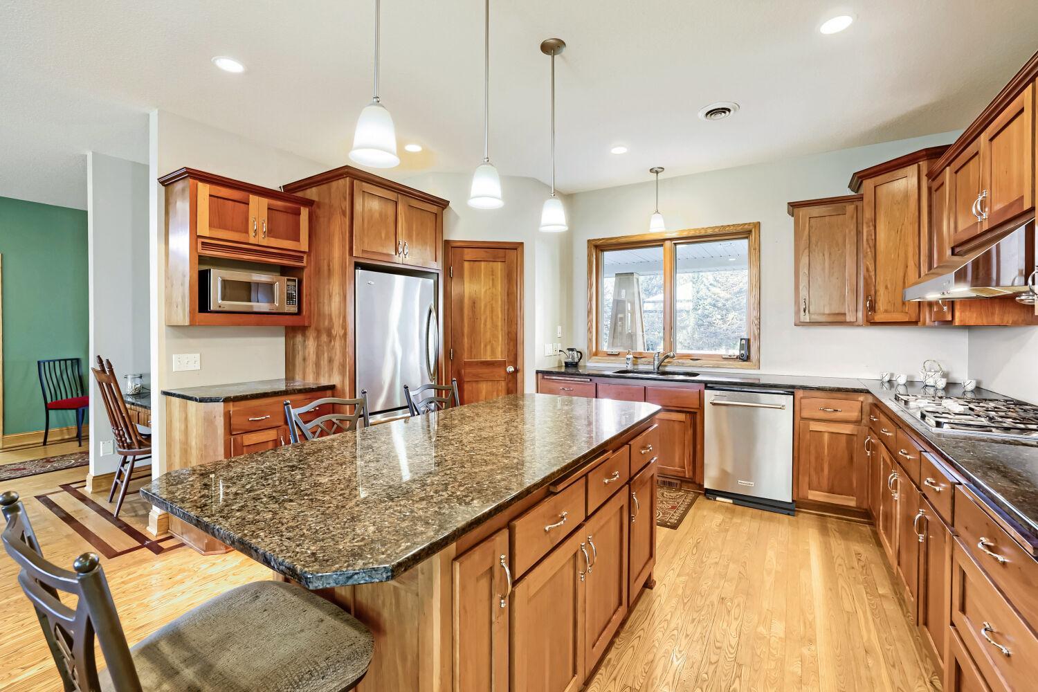 Abundant cabinetry and pantry for storage.