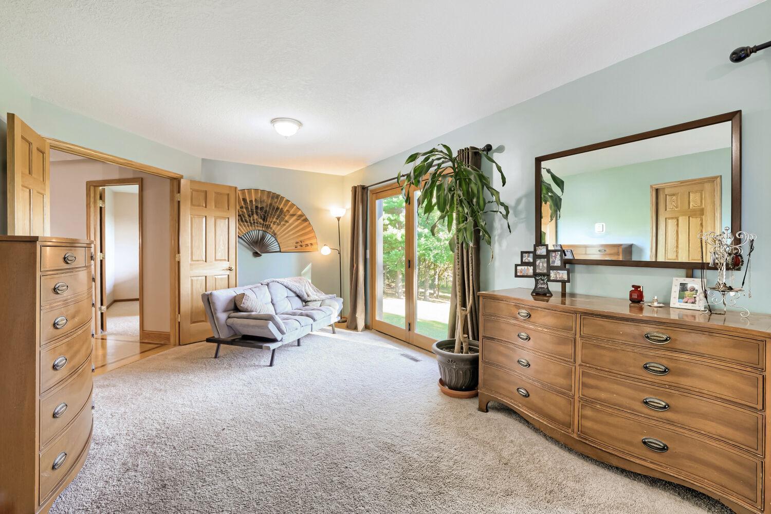 Spacious primary bedroom with sitting area and huge walk-in closet.