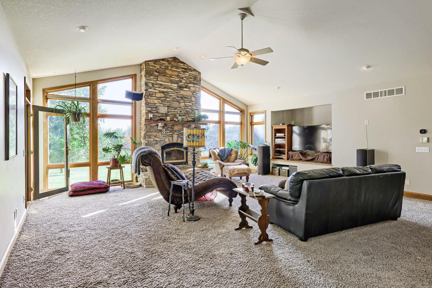 Floor to ceiling windows and woodburning fireplace.
