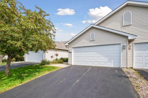 A large asphalt driveway, beautiful vinyl siding, and well-maintained landscaping create a wonderful first impression.