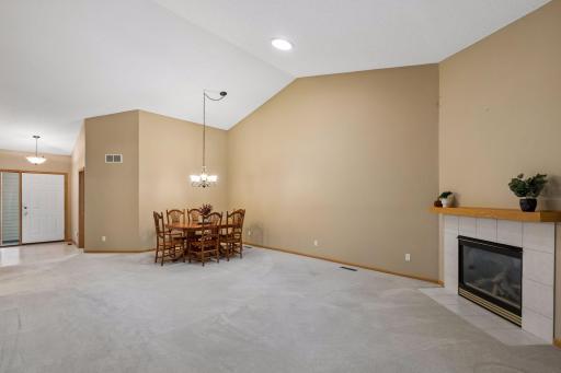 The impressive living room features soaring vaulted ceilings and skylights that bring in even more natural light.