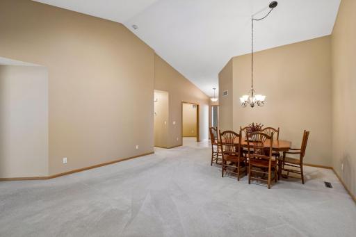 A view from the fireplace toward the dining area, with a full bathroom and generous storage conveniently located just down the hall.