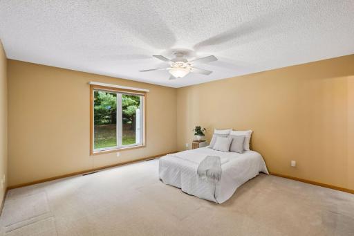 Welcome to the spacious main-level primary bedroom, complete with a new window bringing in wonderful natural light.