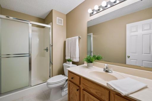 The private primary bathroom features a convenient walk-in shower for easy one-level living.