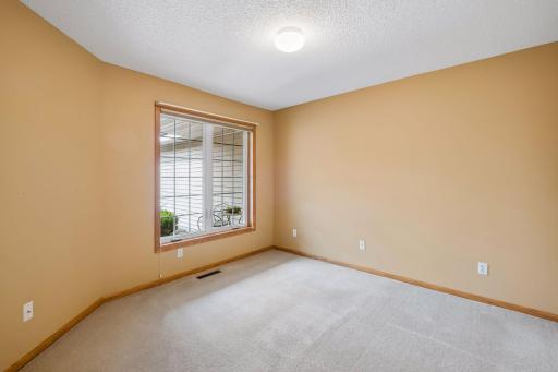 The second main-level bedroom is bright, comfortable, and conveniently located near the full bathroom.