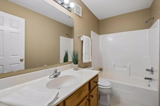 The additional full bathroom is conveniently located just off the main living and dining areas.