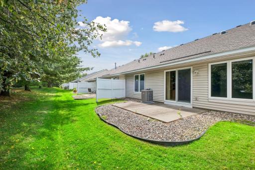 So much beautiful green space just beyond the patio gives you a peaceful backyard setting without the maintenance of a large private yard.