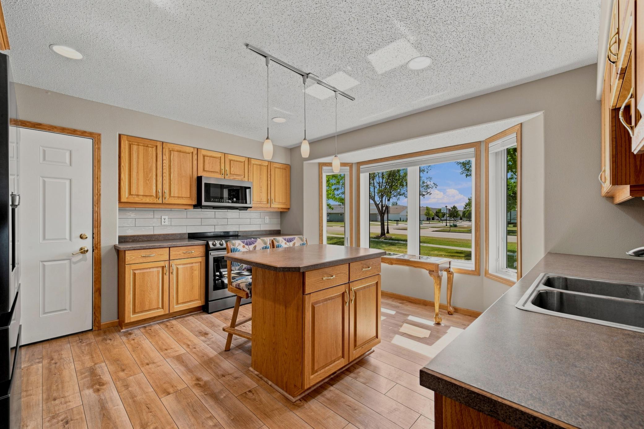 Kitchen offers huge bay window, center island, recessed lights