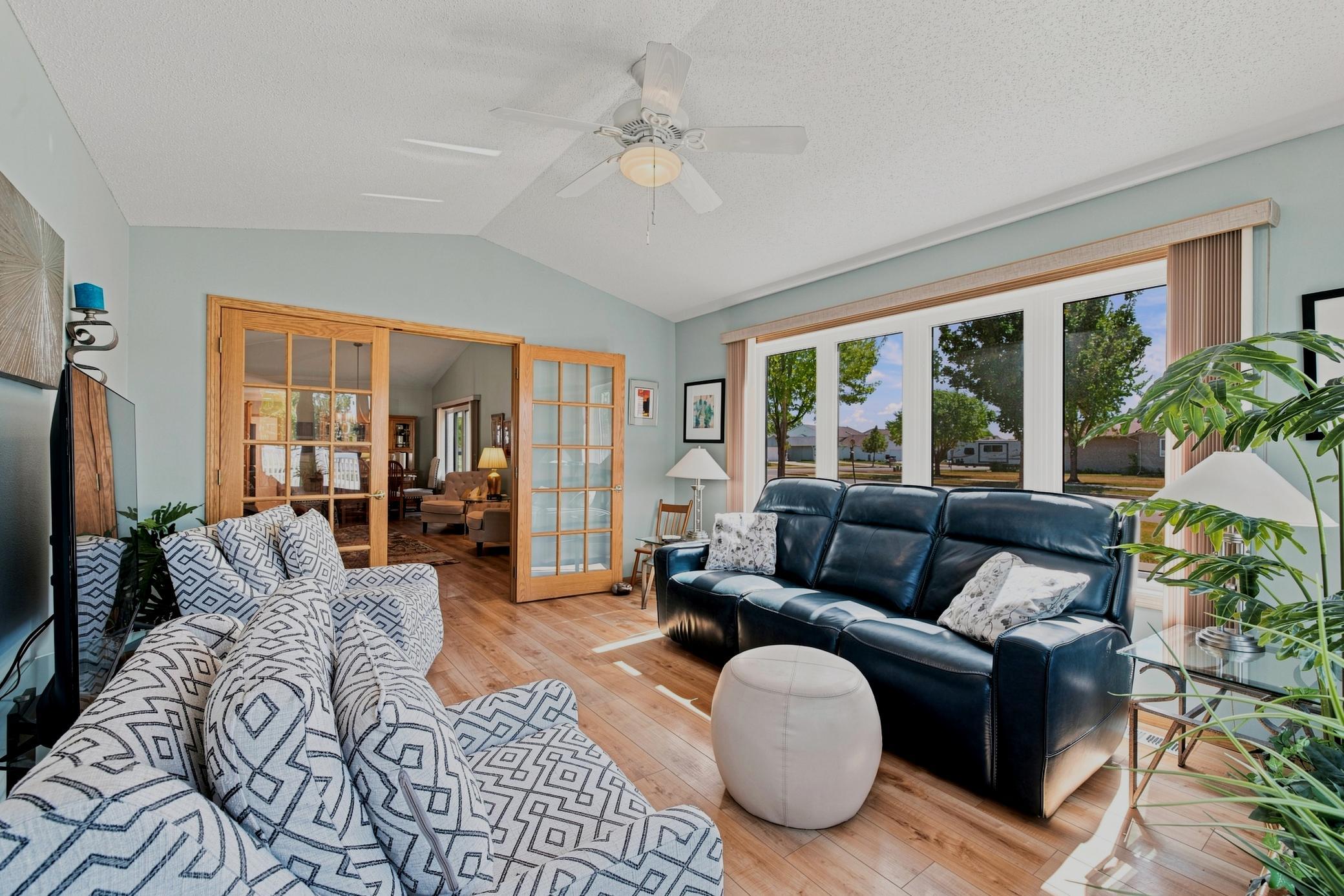 French doors into Living Room, ceiling fan, large windows