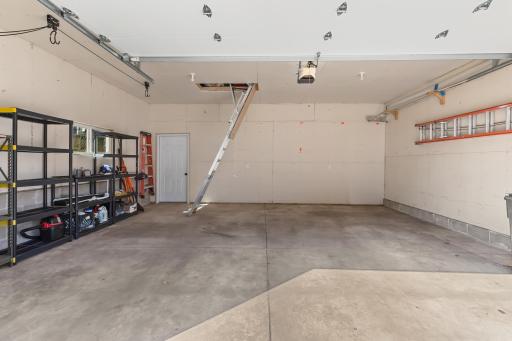Check out the 2 car garage with pull down ladder leading to extra storage