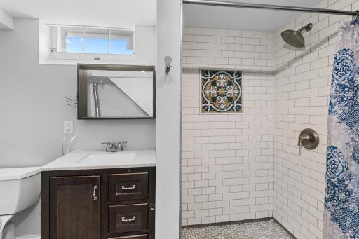 Stylish tile and vanity in lower level bathroom