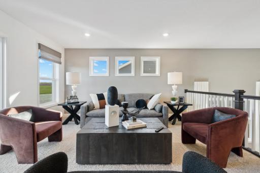(Photo of a decorated model, actual homes finishes will vary) Access the upper level with a short staircase-you will find a wonderful family room, 3 bedrooms (including the owner suite), and a hall bath.