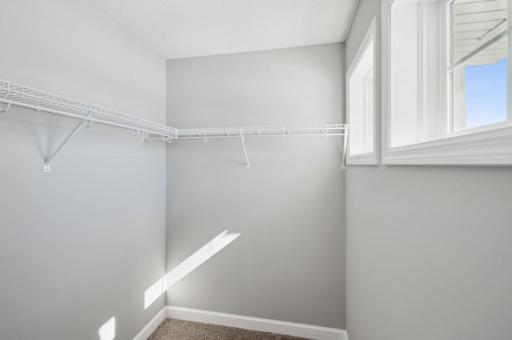 (Photo of a decorated model, actual homes finishes will vary) The primary bedroom features an incredible walk-in closet.
