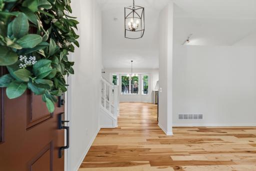 Foyer features vaulted ceilings & hickory hardwood floors